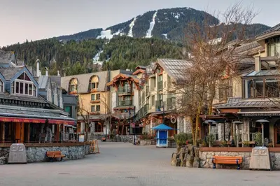 a street in a town with buildings and a mountain at The Alpine Alcove w Pool & Hot Tub in Whistler