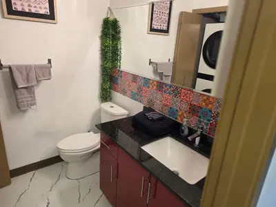 a bathroom with a toilet and a sink and a mirror at Breath-Taking-View-5 Guest DTskyline-18th Floor in Calgary