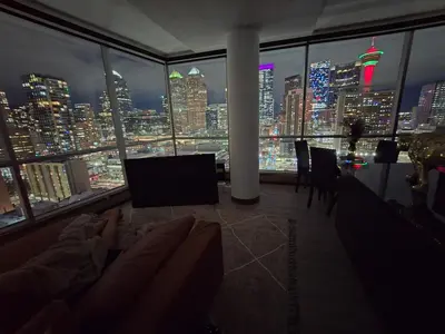 a living room with a view of a city at night at Breath-Taking-View-5 Guest DTskyline-18th Floor in Calgary