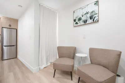 a living room with two chairs and a table at NEW Cambie Village 2 Bed Suite Near Skytrain in Vancouver