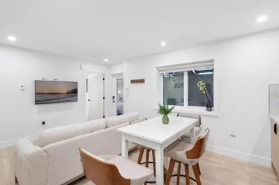 a living room with a couch and a table at NEW Cambie Village 2 Bed Suite Near Skytrain in Vancouver