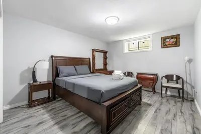 a bedroom with a bed and a desk and a chair at Comfortable Family Home,South Granville in Vancouver