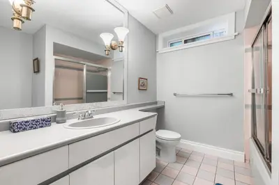 a white bathroom with a sink and a toilet at Comfortable Family Home,South Granville in Vancouver