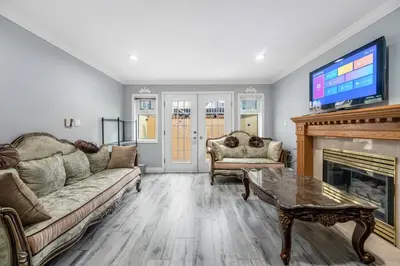 a living room with a couch and a fireplace at Comfortable Family Home,South Granville in Vancouver