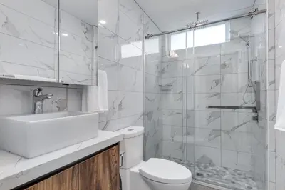 a bathroom with a toilet and a sink and a shower at Modern Downtown Studio Bedroom Walk Everywhere in Vancouver