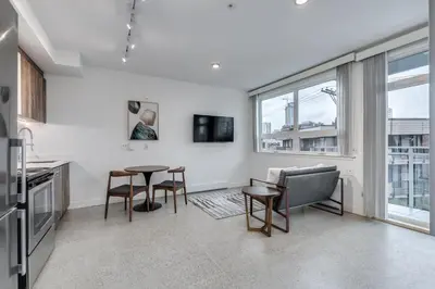 a kitchen with a table and chairs in a room at Modern Downtown Studio Bedroom Walk Everywhere in Vancouver