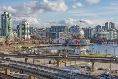 a view of a city with a bridge and buildings at Downtown Suite with Parking, Pool, Gym in Vancouver