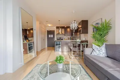 a living room with a couch and a table at Downtown Suite with Parking, Pool, Gym in Vancouver