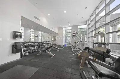 a gym with treadmills and machines in a room at Downtown Suite with Parking, Pool, Gym in Vancouver