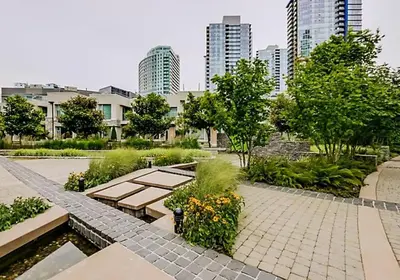 a park with benches and trees and buildings at Downtown Suite with Parking, Pool, Gym in Vancouver