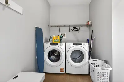 a laundry room with a washing machine and a washer at modern 3bedroom space sleeps 6 free parking in Edmonton