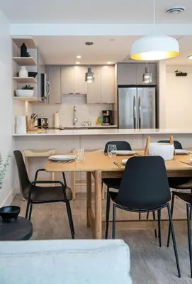 a kitchen and dining room with a wooden table and chairs at Qs Hideaway in Mackenzie Village in Revelstoke