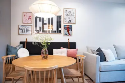 a living room with a table and a couch at The Ceili Cottage in Mackenzie Village in Revelstoke