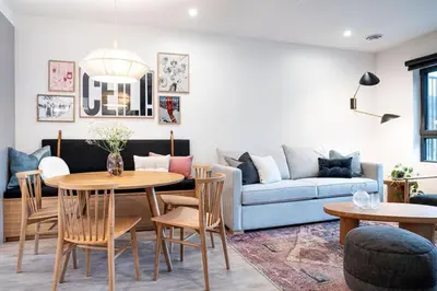 a living room with a couch and a table and chairs at The Ceili Cottage in Mackenzie Village in Revelstoke