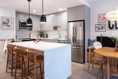 a kitchen with a large white island in a kitchen at The Ceili Cottage in Mackenzie Village in Revelstoke