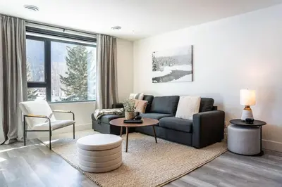 a living room with a couch and a chair at The Peaks and Birdies in Mackenzie Village, Revelstoke in Revelstoke
