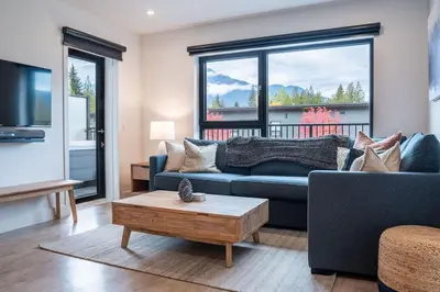 a living room with a couch and a coffee table at Bluebird Daze in Mackenzie Village in Revelstoke
