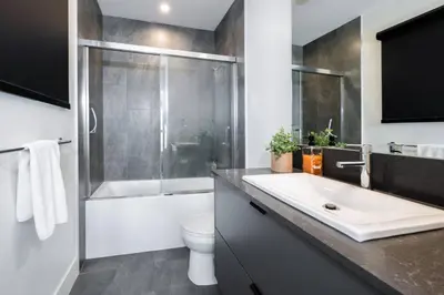 a bathroom with a sink and a shower and a toilet at Alpine Ascent with Hot Tub in Mackenzie Village in Revelstoke
