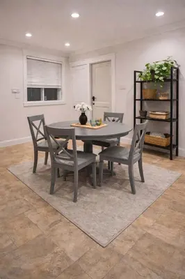 a dining room with a table and chairs and a shelf at Luxury New 2BR Private Suite In Vancouver West Full Kitchen in Vancouver
