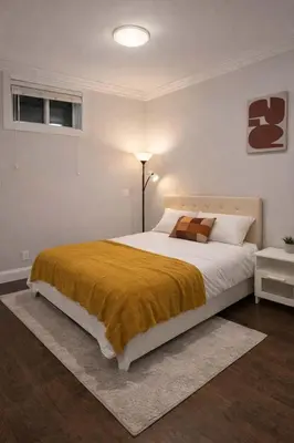 a bedroom with a large bed with a yellow blanket at Luxury New 2BR Private Suite In Vancouver West Full Kitchen in Vancouver