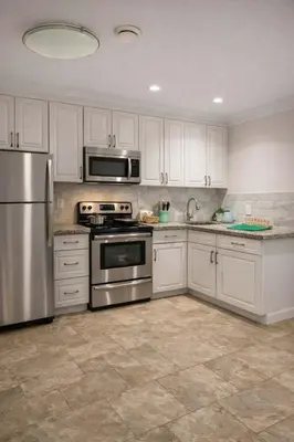 a kitchen with white cabinets and stainless steel appliances at Luxury New 2BR Private Suite In Vancouver West Full Kitchen in Vancouver