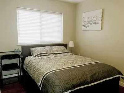 a small bedroom with a bed with a window at EVE'S Room Connect YVR Downtown UBC in Vancouver