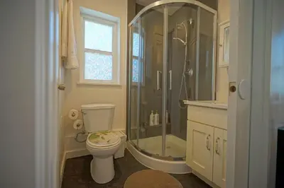 a bathroom with a shower and a toilet and a sink at EVE'S Room Connect YVR Downtown UBC in Vancouver