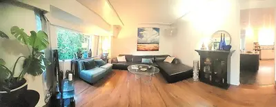 a living room with a couch and a table at Quiet Furnished Room Near Transit and Hospital long stays in Surrey