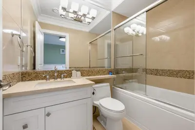 a bathroom with a toilet and a sink and a mirror at An Amazing StarHouse in Westside Vancouver in Vancouver