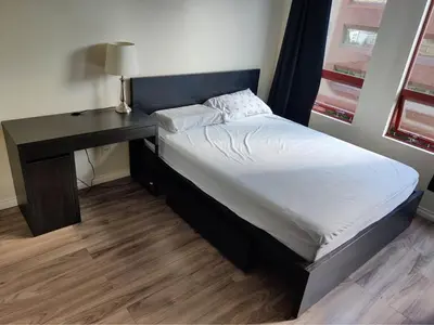 a bed in a room with a desk and a bed at Comfortable 2-Bedroom Downtown Stay Prime Area in Vancouver