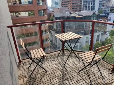 a balcony with two chairs and a table on a balcony at Comfortable 2-Bedroom Downtown Stay Prime Area in Vancouver