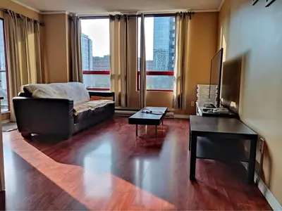 a living room with a couch and a piano at Comfortable 2-Bedroom Downtown Stay Prime Area in Vancouver
