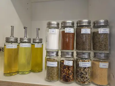 a group of jars filled with different types of spices at Shaganappi 2BR with private Baths, Walk to CTrain, Garage Parking, Full Kitchen in Calgary