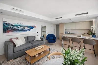a living room with a couch and a kitchen at Downtown 2-Bedroom Apartment with Beautiful City Views in Vancouver