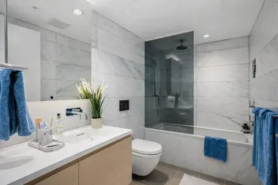a bathroom with a sink and a tub and a toilet at Downtown 2-Bedroom Apartment with Beautiful City Views in Vancouver