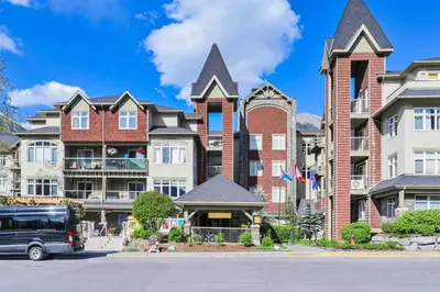 a large brick building with tall spires at 2 Bedroom Condo Banff, Canmore sleeps 6 comfortably in Canmore