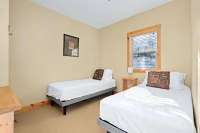 a room with two beds and a window at 2BR Kimberley Escape with Private Hot Tub and BBQ in Kimberley