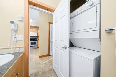 a kitchen with a washer and dryer and a sink at 2BR Kimberley Escape with Private Hot Tub and BBQ in Kimberley