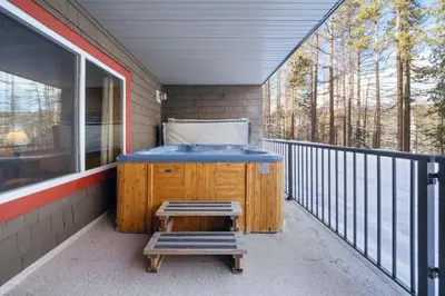 a jacuzzi tub on the porch of a house at 2BR Kimberley Escape with Private Hot Tub and BBQ in Kimberley