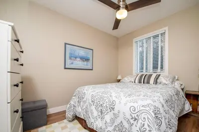 a bedroom with a bed and a window at 3BR Oasis Private Hot Tub and Sauna Walk to Ski Hill in Kimberley