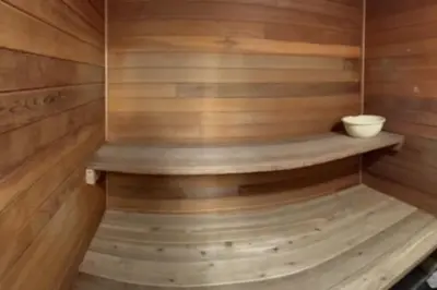 a sauna with wooden walls and a wooden shelf at 3BR Oasis Private Hot Tub and Sauna Walk to Ski Hill in Kimberley