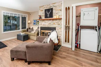 a living room with a couch and a fireplace at 3BR Oasis Private Hot Tub and Sauna Walk to Ski Hill in Kimberley