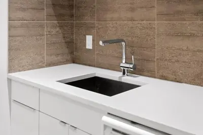 a kitchen with a white sink in a room at Calgary Mini Manor Near DT Sleeps 8 Prime Location in Calgary