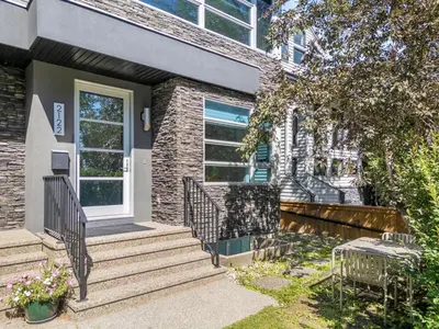 a brick house with stairs and a door at Calgary Mini Manor Near DT Sleeps 8 Prime Location in Calgary