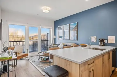 a kitchen and living room with a large window at Cozy 2BR apartment in Golden near DT in Golden
