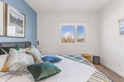 a bedroom with a bed with pillows and a window at Cozy 2BR apartment in Golden near DT in Golden
