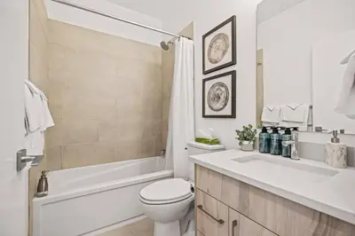 a bathroom with a toilet and a tub and a sink at Cozy 2BR apartment in Golden near DT in Golden