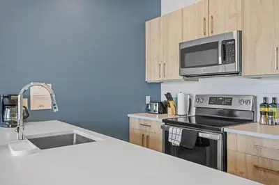 a kitchen with a sink and a microwave at Cozy 2BR apartment in Golden near DT in Golden