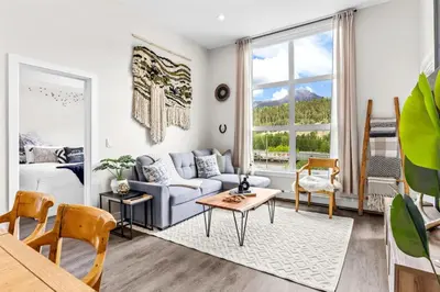 a living room with a couch and a table at Luxe 3BR Golden Hideaway Top Floor, Balcony & BBQ in Golden