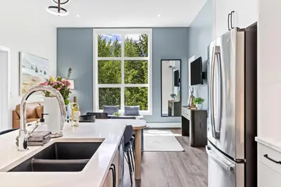 a kitchen with a sink and a refrigerator at Scenic Riverstone 2BR w/ Balcony + BBQ, Sleeps 6! in Golden